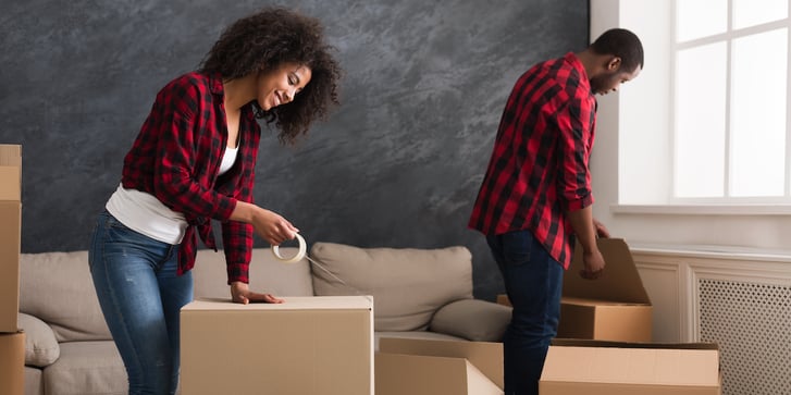 young couple packing boxes at home
